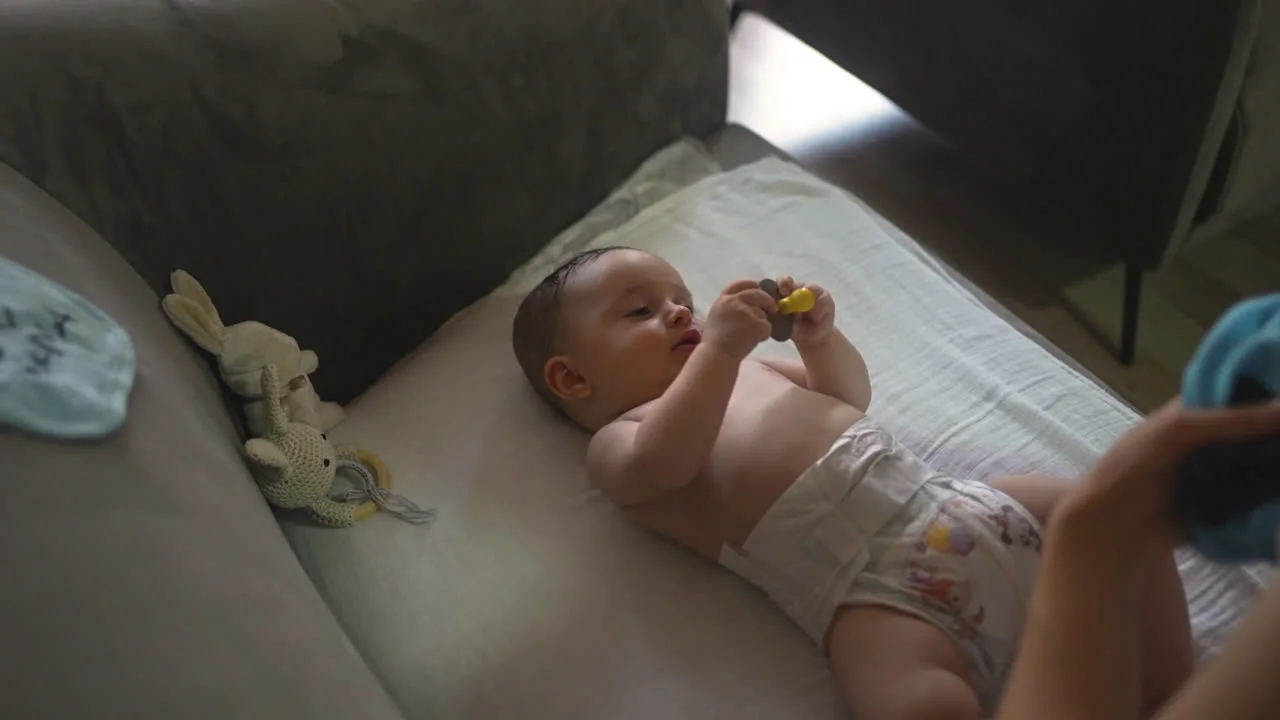 Happy baby relaxing in a soft diaper